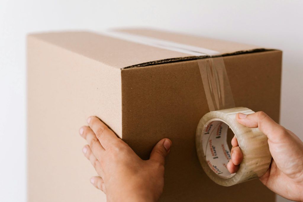 man taping box